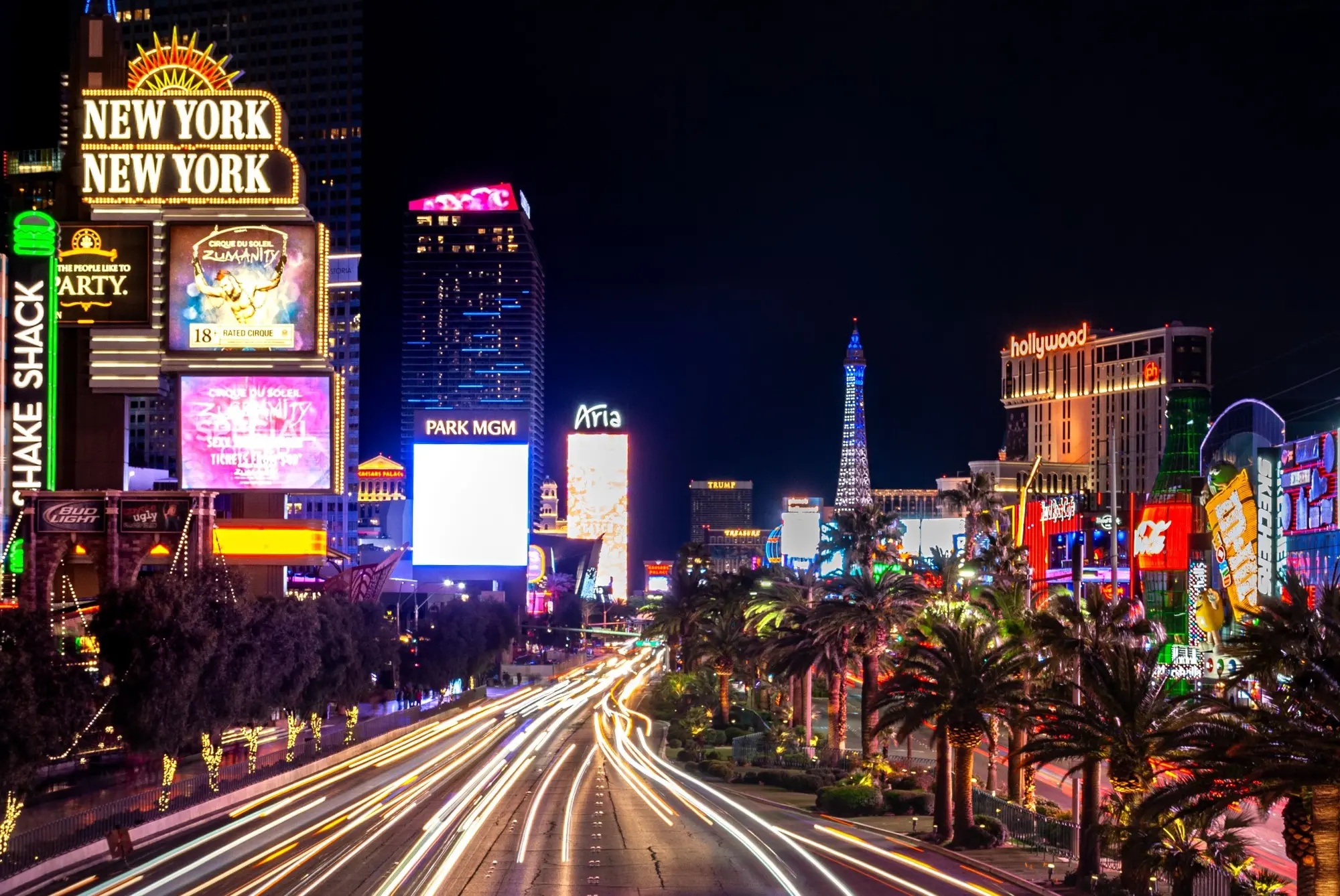 Las Vegas Boulevard glowing at night with streams of moving traffic